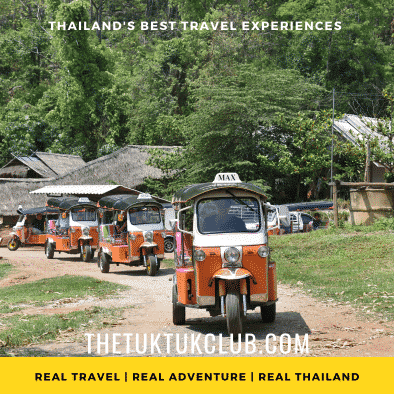 Three Tuk Tuks in convoy on a dirt road in the mountains of Northern Thailand with bright blue skies