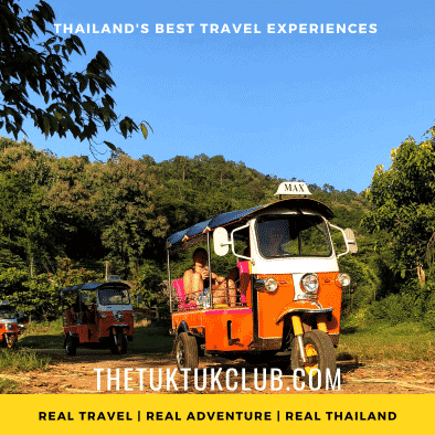 Three Tuk Tuks in convoy on a dirt road in the mountains of Northern Thailand with bright blue skies