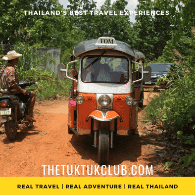 A Tuk Tuk on a small dirt road stopped to talk to a farmer on a small motor bike