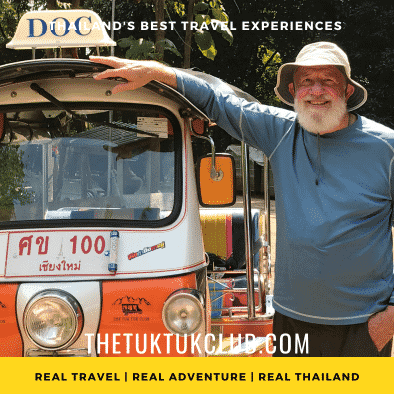 A man with a big smile standing next to his Tuk Tuk on a Thailand Adventure