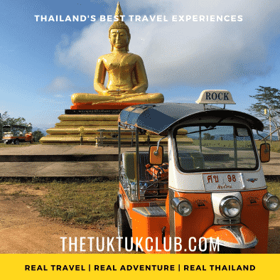 A Tuk Tuk in front of a giant golden Buddha image on a mountain top in Northern Thailand