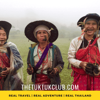 Three Karen Hill Tribe women smiling and smoking after a day working in the fields