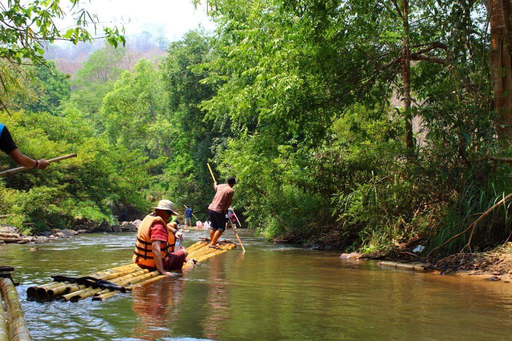 TUK TUK TOURS IN CHIANG MAI 2 Two people floating downstream on bamboo rafts