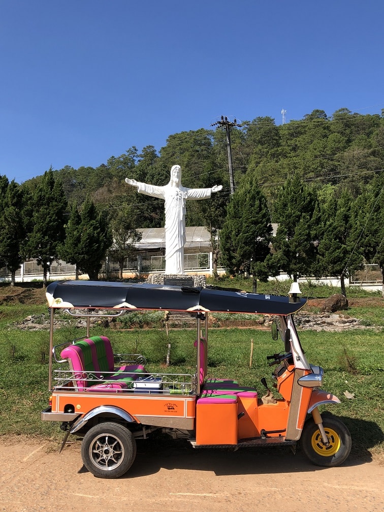 What is a Tuk Tuk? 1 A Tuk Tuk in front of a statue of Jesus Christ