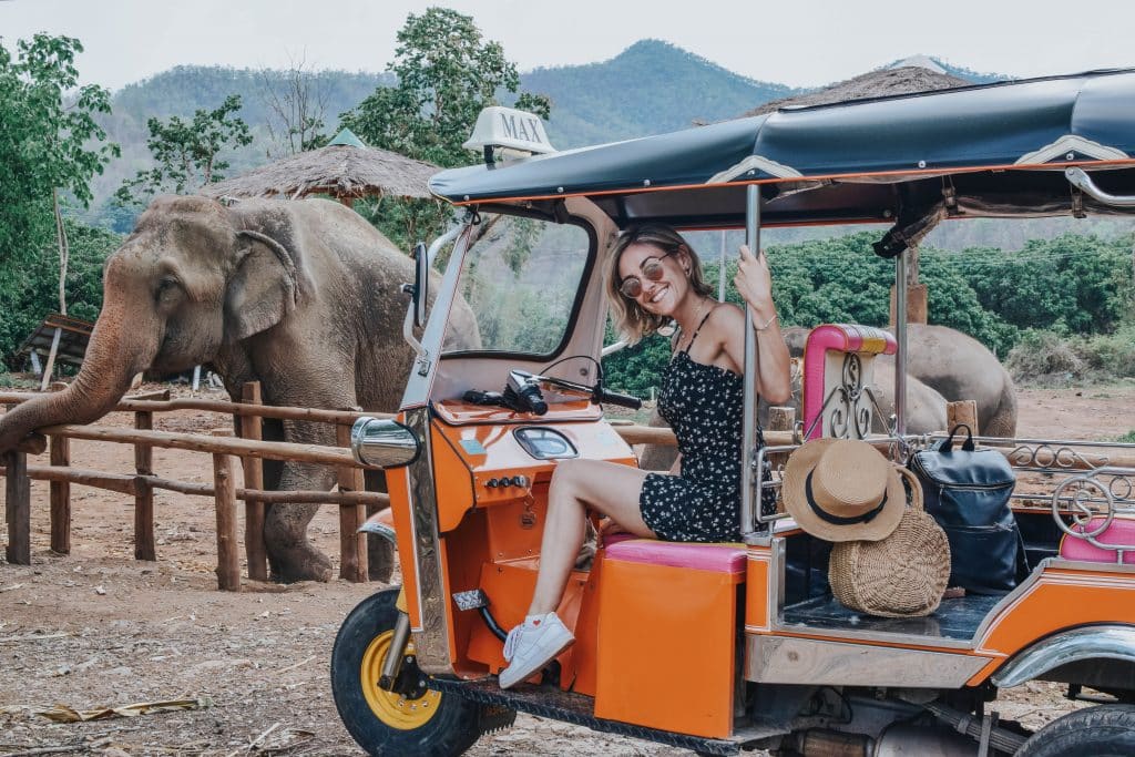IS A 'TUK TUK CLUB ADVENTURE' RIGHT FOR YOU? 1 Young woman sitting in a Tuk Tuk in front of elephants