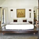 A double bed in a white bedroom at a resort in Northern Thailand