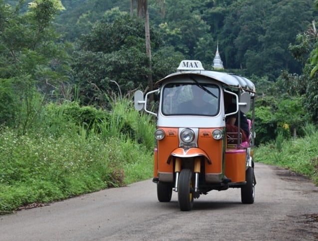 Is travelling by Tuk Tuk in Northern Thailand comfortable? 2 Tuk Tuk driving on a small road in the Thai countryside