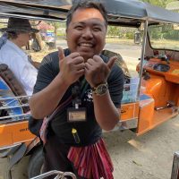 A Thai man smiling with his thumb up